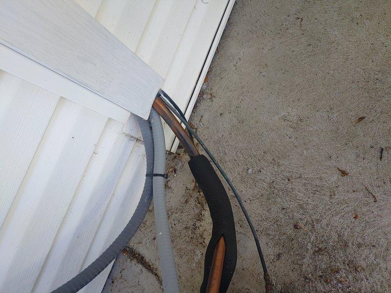 Responded to service callback regarding previous technician visit and leak search recommendation. Performed thorough system inspection of outdoor unit and refrigerant line routing along building exterior. Documented condition of refrigerant lines where they exit the building and transition to concrete pad, noting proper mounting and insulation integrity. Inspected building penetrations and areas where recent roofing work may have impacted HVAC components. Photographed refrigerant line routing and exterior mounted equipment for documentation purposes. Explained to customer the correlation between roofing work and potential refrigerant system compromise, clarifying how overhead construction activities can affect line sets and connections. Reviewed necessity of leak search procedure when system performance issues coincide with recent building work. System requires leak detection service to identify any refrigerant loss and pinpoint exact location of potential leak before repairs can be co