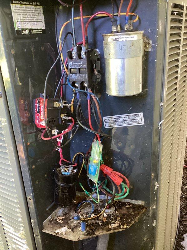 Completed preventive maintenance visit on 18-year-old residential air conditioning system for MVP customer. Inspected electrical components including MARS capacitor, contactor relay, and hard start assembly, verifying all connections were secure. Removed accumulated debris, leaves, and organic material from base of electrical compartment and exterior condenser unit to prevent airflow restriction and potential component damage.
