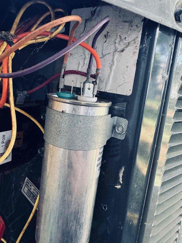 Completed recurring maintenance visit on 11-year-old heating system. Performed comprehensive inspection of electrical components including capacitor examination and voltage testing. Capacitor showed normal surface weathering consistent with age but remained functional with proper electrical connections intact. Used digital multimeter to verify system voltage readings, which measured 60.2V and within acceptable parameters. All wire connections were secure with no signs of overheating or degradation. Unit operating properly at time of service completion.