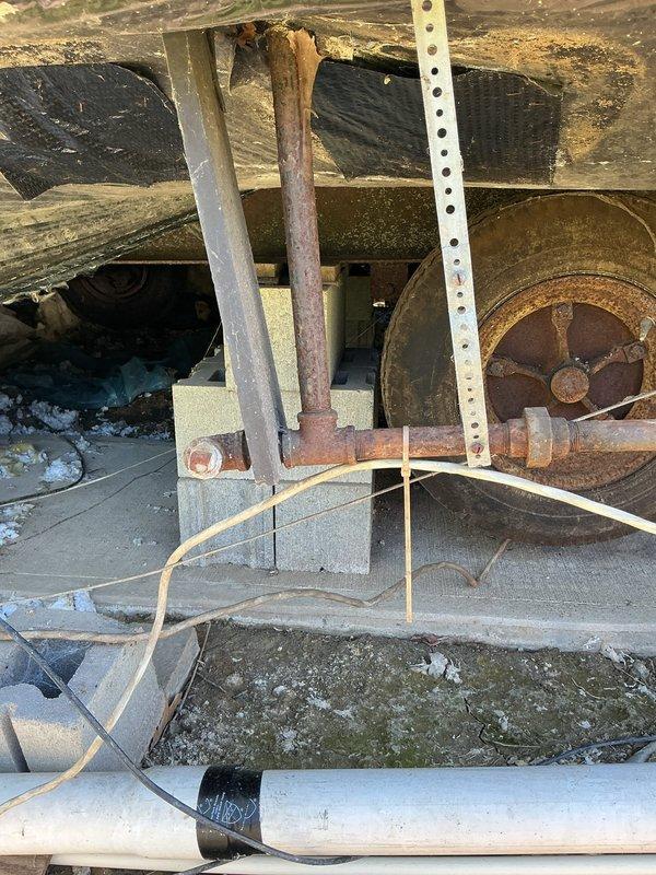 Conducted comprehensive inspection of crawl space plumbing and gas line infrastructure to provide estimate for complete replacement of all gas lines and plumbing pipes. Assessed existing deteriorated conditions including corroded metal pipes, aged PVC water lines with visible degradation, and identified active water leak in piping system. Documented extensive weathering of existing utility infrastructure, compromised insulation, and structural accessibility for planned replacement work.