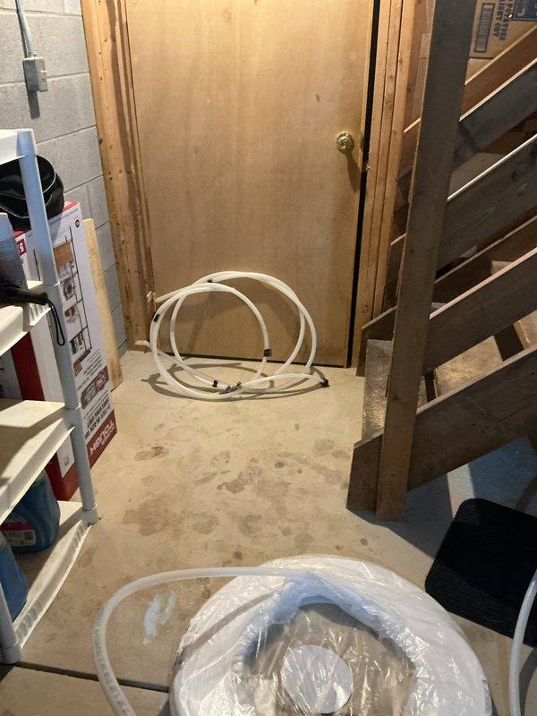 Completed in-house warranty repair on sump pump discharge system. Installed plug into existing PVC pipe at current discharge point. Replaced and relocated discharge tubing to sump pump, upgrading line size from existing configuration to 3/4" poly pipe for improved drainage capacity and system performance.