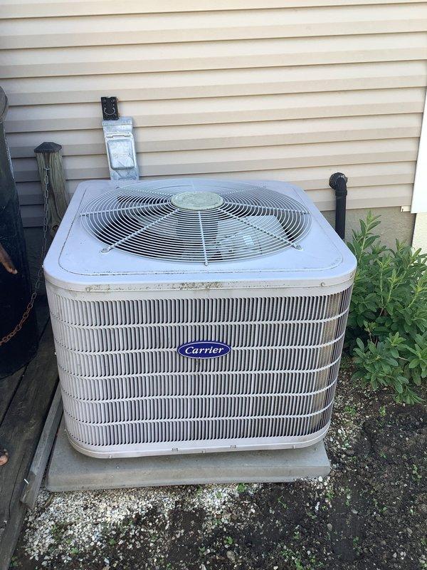 Responded to no cooling complaint on Carrier air conditioning system. Upon arrival, found unit running but not moving air through indoor system. Inspected outdoor condensing unit and tested capacitor using clamp meter. Diagnosed failed capacitor preventing proper compressor and fan motor operation. Replaced defective capacitor with properly rated component, restored system to normal operation, and verified adequate airflow and cooling performance.