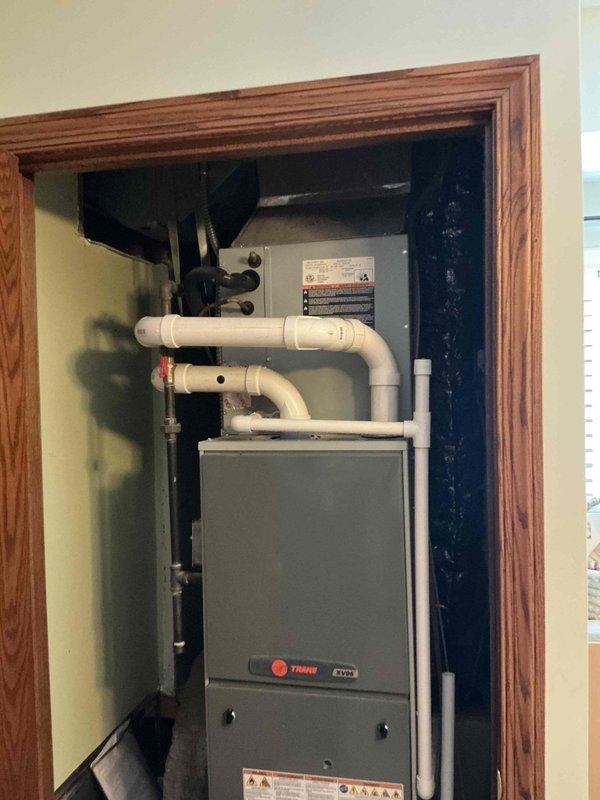 Conducted comprehensive estimate for complete HVAC system replacement including furnace and air conditioning unit. Evaluated existing Trane XL80 furnace installed in interior utility closet with PVC venting and assessed outdoor condensing unit mounted on concrete pad with proper electrical disconnect. Documented current equipment configuration, venting arrangements, and installation conditions to provide accurate replacement specifications and pricing for new heating and cooling system.