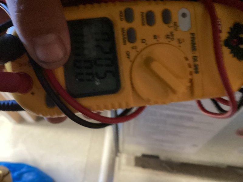 Completed MVP recurring cooling maintenance visit on residential air conditioning system. Performed electrical diagnostics using digital multimeter to verify proper voltage and amperage readings at the outdoor condenser unit. Inspected exterior condensing unit showing weathering and algae growth on lower sections; unit operational with all components functioning within normal parameters.