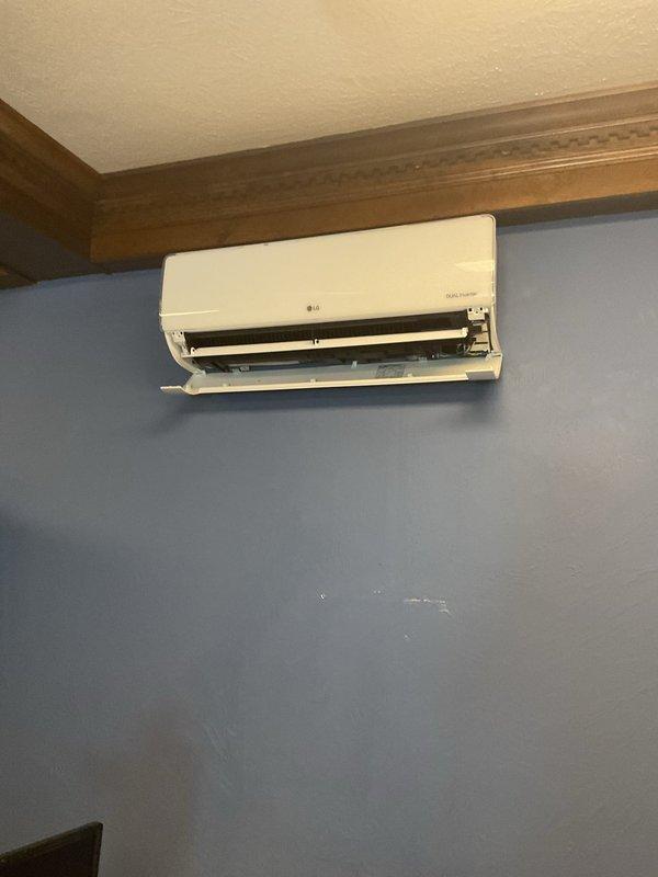 Responded to service call for 3-year-old LG mini split system experiencing water leakage. Inspected wall-mounted indoor unit and accessed attic space above to examine condensate drain line routing and connections. Identified drainage issue, cleared blockage from condensate line, verified proper pitch and flow, and tested system operation to confirm leak was resolved.