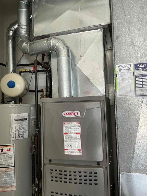 Conducted on-site HVAC system evaluation for equipment replacement estimate at residential property. Assessed existing Lennox furnace installation, ductwork configuration, and associated mechanical components including expansion tank and piping connections. Documented current system layout and equipment specifications through detailed photography to support replacement proposal development.