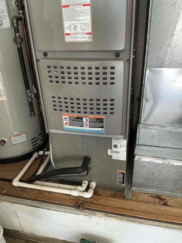 Conducted on-site HVAC system evaluation for equipment replacement estimate at residential property. Assessed existing Lennox furnace installation, ductwork configuration, and associated mechanical components including expansion tank and piping connections. Documented current system layout and equipment specifications through detailed photography to support replacement proposal development.