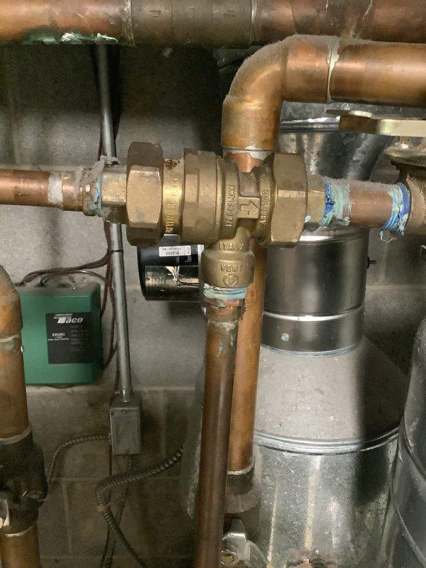 Responded to service call for water leak on 9-year-old residential gas boiler. Upon inspection, discovered moisture accumulation at base of unit and around piping connections. Identified leak source at brass valve fitting in copper piping network near circulator pump assembly. Tightened valve connections and inspected associated piping joints for additional compromised fittings. Verified expansion tank operation and checked system pressure. Monitored unit through heating cycle to confirm leak resolution and proper system operation. All components functioning within normal parameters upon completion.
