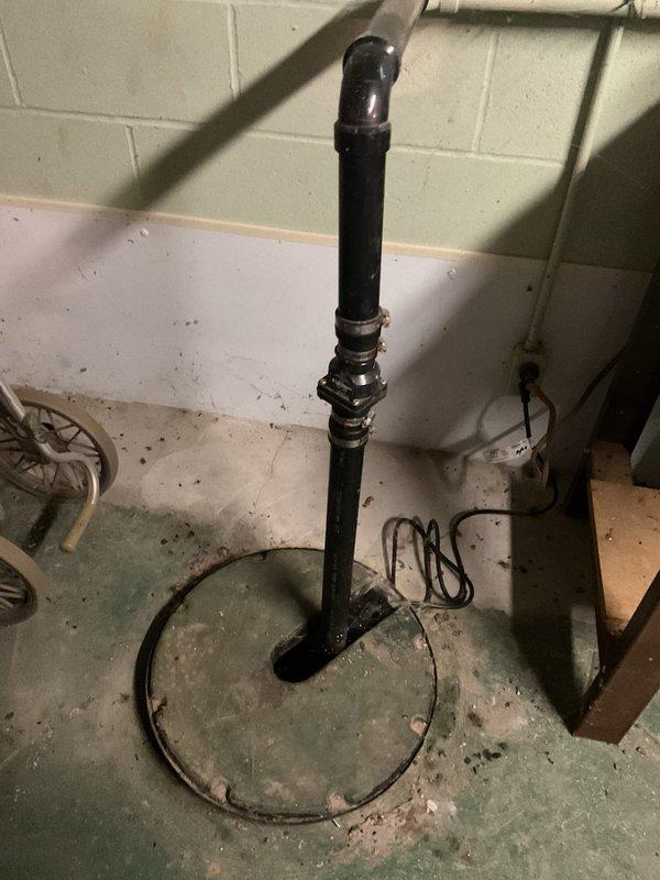 Performed comprehensive maintenance inspection on 18-year-old sump pump system in basement utility area. Accessed sump pump basin, verified proper operation of pump mechanism, and inspected discharge piping assembly including vertical standpipe and associated fittings. Examined basin for sediment accumulation, mineral deposits, and structural integrity. Tested pump float switch operation and confirmed electrical connections were secure. Additionally addressed outdoor spigot issue on south side of property requiring handle replacement or repair to restore functionality.