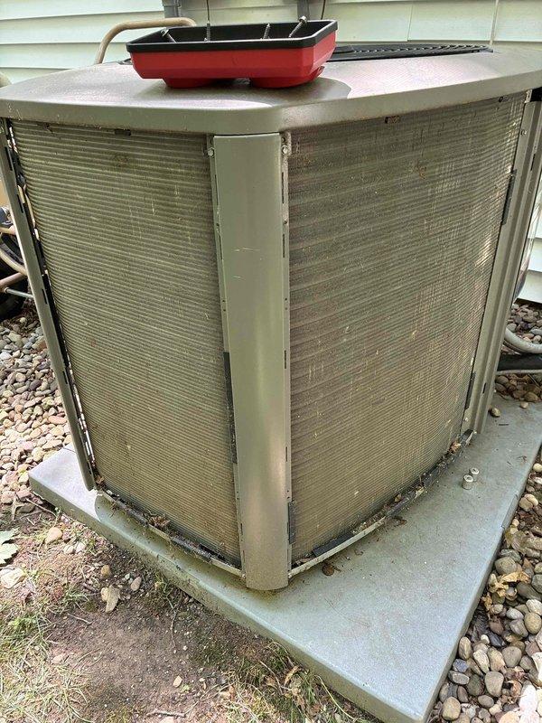Completed MVP cooling maintenance visit on 6-year-old residential air conditioning system. Performed comprehensive inspection of outdoor condenser unit, noting moderate dust and grime accumulation on metal louvers and fins consistent with normal environmental exposure. Unit operational with standard weathering appropriate for age and outdoor installation on concrete pad with rock landscaping.