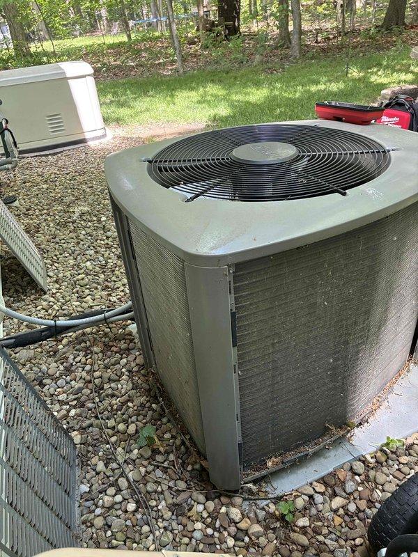 Completed MVP cooling maintenance visit on 6-year-old residential air conditioning system. Performed comprehensive inspection of outdoor condenser unit, noting moderate dust and grime accumulation on metal louvers and fins consistent with normal environmental exposure. Unit operational with standard weathering appropriate for age and outdoor installation on concrete pad with rock landscaping.