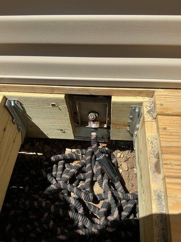 Responded to service call for hose stuck on exterior hose bib at 1930s-era residential property. Upon arrival, assessed the frozen connection between garden hose and outdoor spigot fixture with no visible signs of active leaking or water damage present. Provided estimate for hose removal service to address the stuck connection. Documented existing conditions of outdoor plumbing fixture and surrounding installation area through photographic records for customer reference.