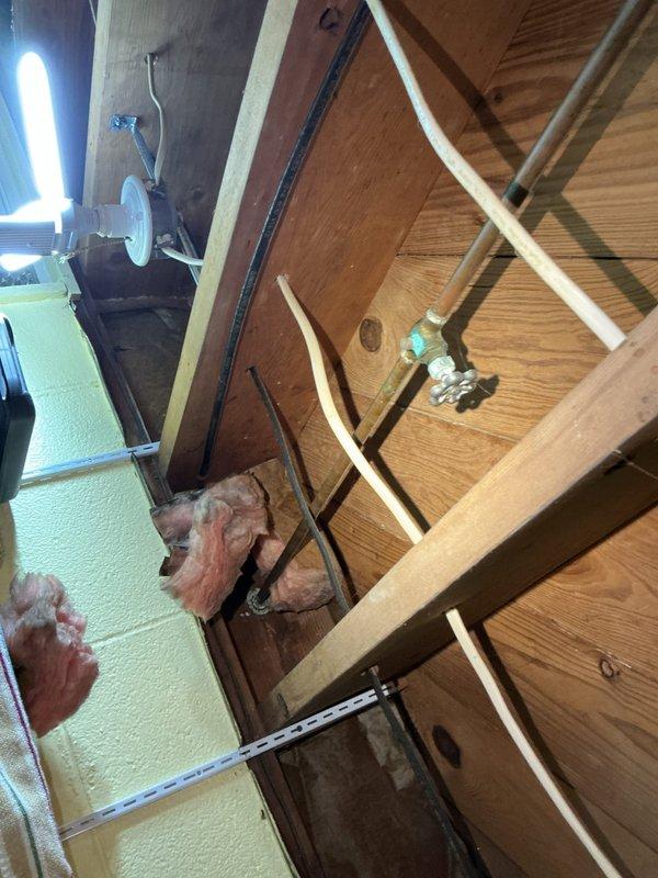 Responded to service call for hose stuck on exterior hose bib at 1930s-era residential property. Upon arrival, assessed the frozen connection between garden hose and outdoor spigot fixture with no visible signs of active leaking or water damage present. Provided estimate for hose removal service to address the stuck connection. Documented existing conditions of outdoor plumbing fixture and surrounding installation area through photographic records for customer reference.