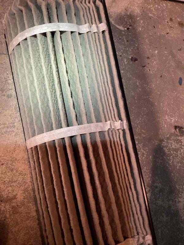 Responded to report of significant furnace water leak. Upon inspection, discovered severely deteriorated condensate drain line insulation with active water dripping from damaged sections. Found heavily contaminated air filter with substantial discoloration indicating poor airflow and moisture infiltration. Documented conditions with photographs showing compromised insulation integrity and filter saturation, requiring immediate attention to prevent further water damage and restore proper system operation.