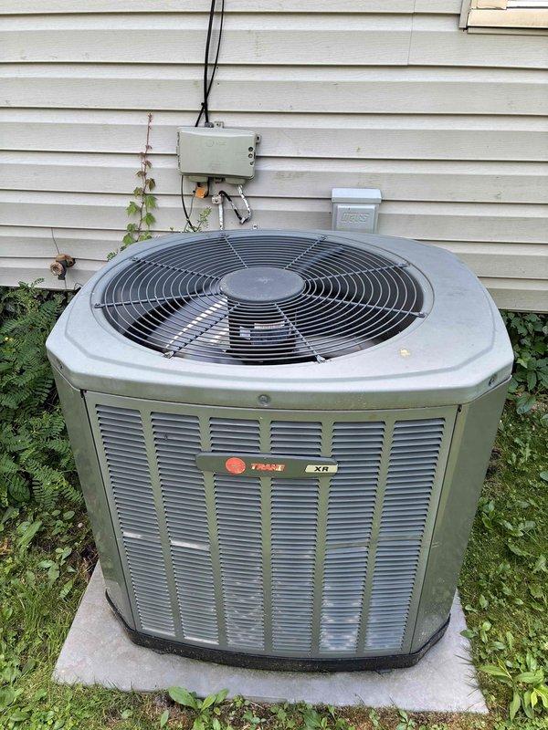 Completed MVP cooling maintenance visit on 11-year-old Trane XR octagonal condenser unit. Performed comprehensive system inspection including exterior condenser examination, verified operational status of fan motor and compressor, and checked electrical connections at disconnect box. Inspected and serviced air filter at indoor air handler, noting moderate dust accumulation indicating proper filtration. All components found operating within normal parameters for unit age, with routine maintenance tasks completed to ensure continued system performance.