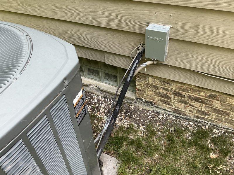 Conducted comprehensive site assessment for HVAC system replacement on residential property with 19-year-old existing equipment. Evaluated current outdoor condensing unit installation, electrical disconnect configuration, and conduit routing along foundation. Documented existing system placement on concrete pad with gravel base, assessed clearance requirements, and photographed electrical connections from wall-mounted disconnect box to unit. Prepared detailed replacement estimate including equipment specifications and installation requirements for aging air conditioning system.