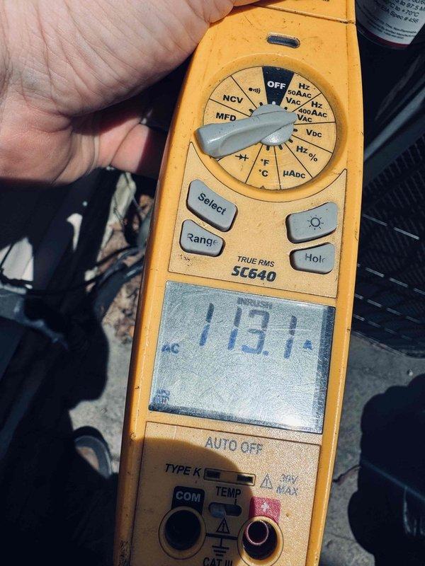 Responded to service call for non-operational outdoor condensing unit with loud noise, inoperative condenser fan motor, and no cooling. Upon arrival, confirmed fan motor was not running and motor housing was excessively hot to touch. Performed diagnostic testing using digital multimeter, measuring voltage at terminal block to verify power supply to unit. Reading indicated 118.1 VAC at electrical connection point. Inspected electrical connections and wiring at terminal block for loose connections, damaged wires, or signs of overheating. Based on age of equipment (approximately 20 years old) and symptoms presented, determined condenser fan motor had failed, causing system to overheat and cease cooling operation.