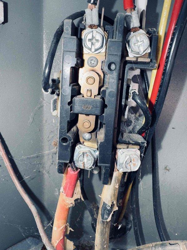 Responded to service call for non-operational outdoor condensing unit with loud noise, inoperative condenser fan motor, and no cooling. Upon arrival, confirmed fan motor was not running and motor housing was excessively hot to touch. Performed diagnostic testing using digital multimeter, measuring voltage at terminal block to verify power supply to unit. Reading indicated 118.1 VAC at electrical connection point. Inspected electrical connections and wiring at terminal block for loose connections, damaged wires, or signs of overheating. Based on age of equipment (approximately 20 years old) and symptoms presented, determined condenser fan motor had failed, causing system to overheat and cease cooling operation.