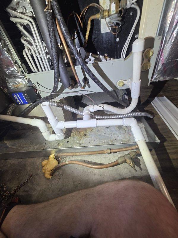 # HVAC Service Completed

Responded to service call for attic air conditioning unit leaking through ceiling with inadequate cooling performance. Unit was running but unable to maintain setpoint temperature, with attic temperature reading 80°F against a 75°F thermostat setting.

Upon inspection, discovered severely corroded dual-run capacitor with extensive rust and oxidation buildup on terminals and wire connections. The deterioration indicated prolonged moisture exposure and component failure, which was causing improper compressor and condenser fan motor operation. This capacitor failure was the primary cause of the cooling deficiency.

Additionally, identified active condensate drainage issue contributing to the ceiling leak. Inspected condensate drain system including primary drain line, secondary overflow line, and drain pan condition.

Replaced failed capacitor with new properly-rated unit, ensuring all electrical connections were secure and properly terminated. Cleared condensate