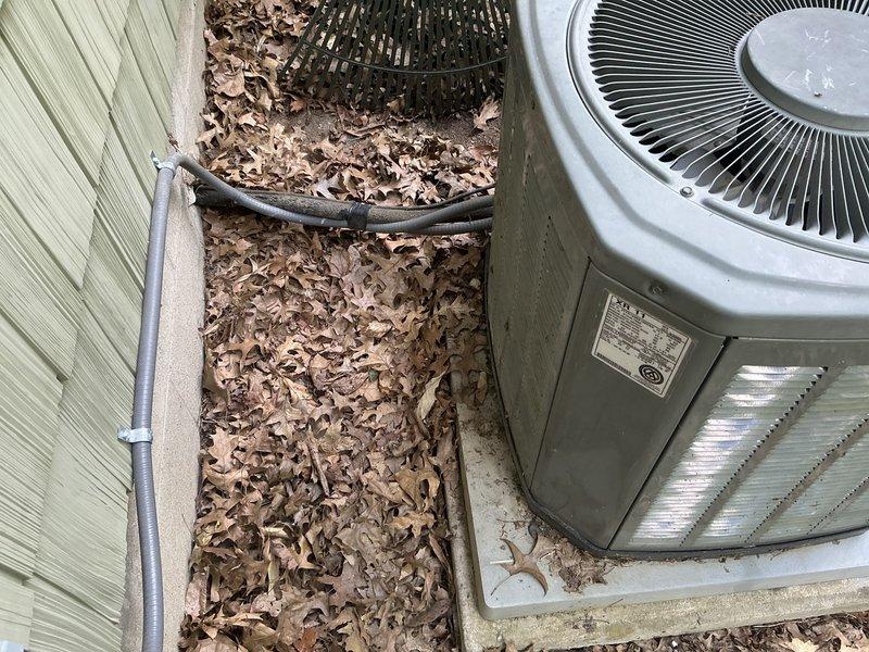 Provided estimate for complete HVAC system replacement on a 21-year-old unit experiencing no cooling condition. The existing outdoor condenser unit showed significant leaf debris accumulation on and around the equipment, and the indoor air handler components displayed age-related wear consistent with the system's service life, necessitating full system replacement rather than repair.