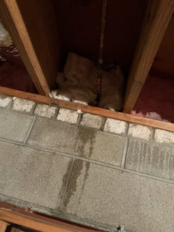 Responded to service call for outdoor spigot repair in crawl space area. Upon inspection, accessed the exterior hose bib connection through interior framing near foundation wall. Replaced failed freeze-damaged outdoor faucet assembly, including valve body and connecting copper piping. Secured new installation within wooden framing structure, ensuring proper insulation coverage around pipes to prevent future freeze damage. Verified system integrity with pressure test and confirmed no active leaks at connection points.