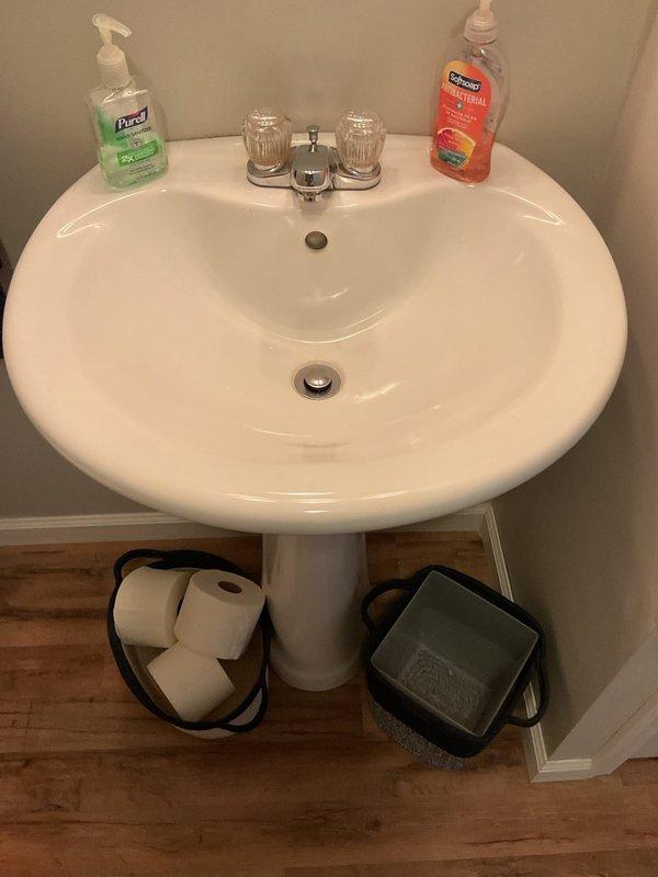 Responded to report of basement drain leaking yellow and brown water, potentially from main drain line. Upon inspection, assessed plumbing fixtures including basement drainage system, toilet, and pedestal sink. Additionally evaluated kitchen faucet for reported slow leak. Documented conditions of bathroom fixtures and surrounding areas to determine source of drainage issue and identify necessary repairs.