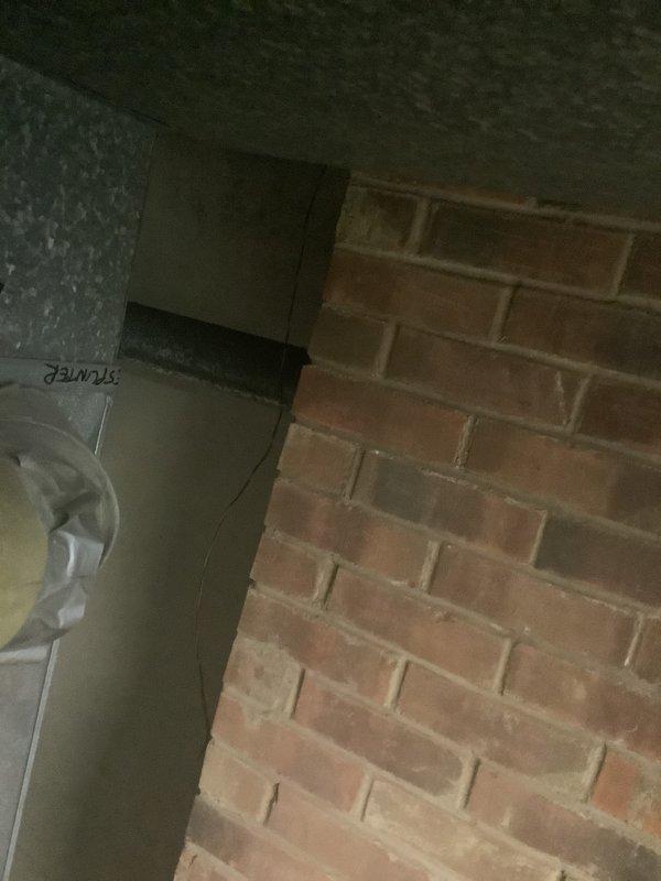Conducted on-site assessment for furnace and air conditioning system replacement in residential utility area with brick wall construction. Evaluated existing HVAC equipment configuration and documented current installation conditions including clearances, venting arrangements, and electrical service to provide comprehensive replacement estimate for new heating and cooling system.