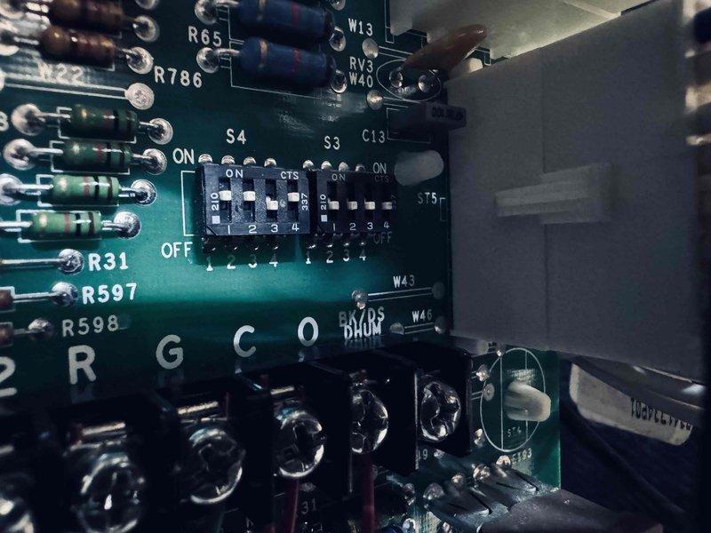 Completed MVP recurring cooling maintenance visit. Performed electrical diagnostics using digital multimeter, measuring amperage draw at 10.8A and secondary reading of 8.0A to verify proper system operation. Inspected control board components including resistors, capacitors, and DIP switch configuration settings for proper function and connections.