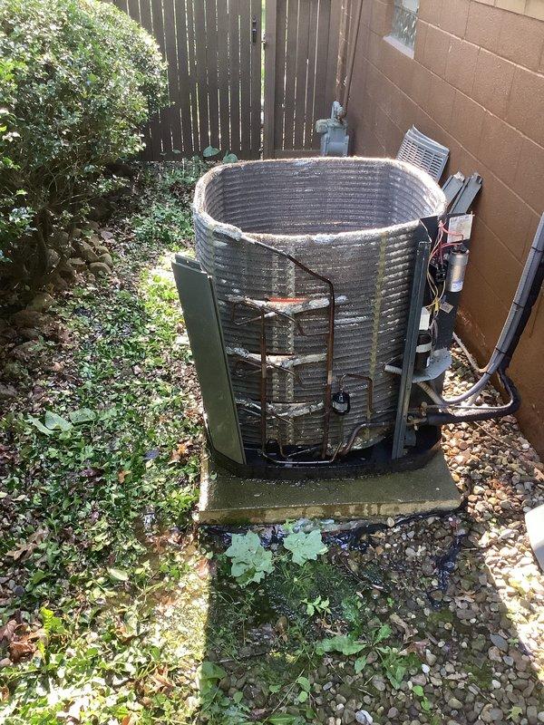 Performed comprehensive AC tune-up on residential outdoor condenser unit. Completed standard maintenance protocol including inspection of all mechanical components, refrigerant lines, electrical connections, and control systems. Unit found in operational condition with vegetation encroachment noted around equipment base; customer advised on importance of maintaining clearance for proper airflow and system efficiency.