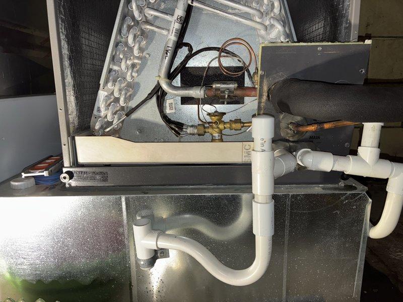 Responded to service call for 3-year-old basement mini-split system with water leaking throughout basement during operation. Upon inspection, found compromised condensate drainage system with standing water in drain pan and evidence of moisture damage to surrounding structural components. Inspected air handler unit, evaporator coil, and condensate pump assembly; identified drainage issues causing water overflow and verified proper operation of condensate removal system to resolve leaking condition.