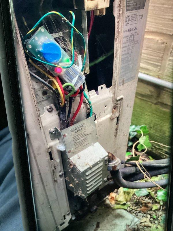 Responded to no cooling complaint on 16-year-old mini split system serving second floor master bedroom. Upon inspection, outdoor condenser unit showed significant age-related weathering and debris accumulation. Accessed electrical panel and evaluated internal components including capacitor, transformer, and wiring connections for proper operation and potential failure points contributing to loss of cooling capacity.