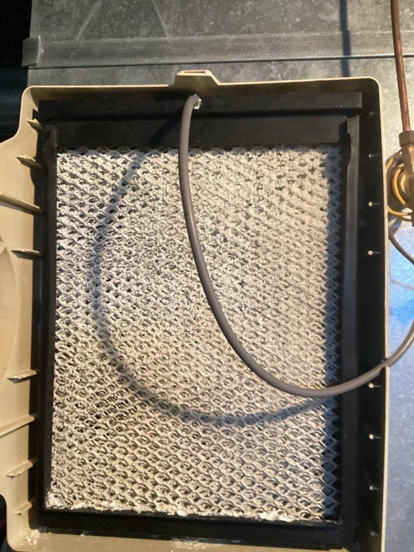 Completed scheduled preventive maintenance cooling visit on 13-year-old Lennox HVAC system. Performed comprehensive inspection of air handler unit, including examination of evaporator coil which showed normal honeycomb pattern with no visible debris accumulation or damage. Verified proper drainage line routing and confirmed refrigerant lines were secure with no signs of leakage. Inspected auxiliary Accuaire component and main furnace cabinet for proper operation. All system components functioning within normal parameters at time of service.