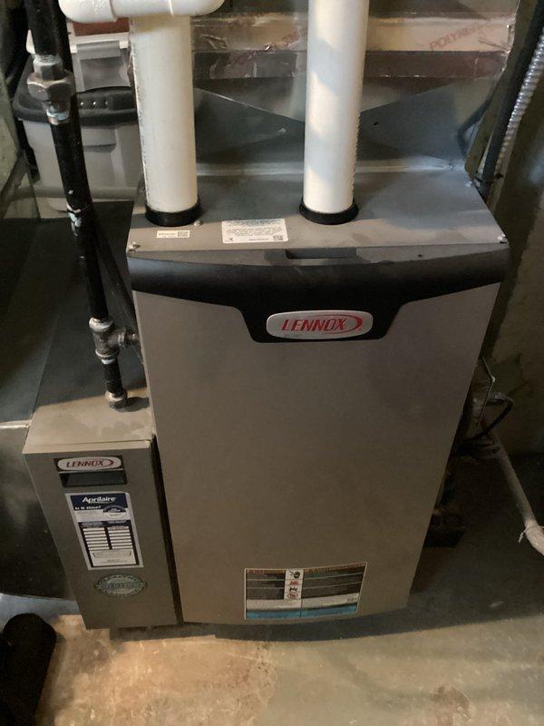 Completed scheduled preventive maintenance cooling visit on 13-year-old Lennox HVAC system. Performed comprehensive inspection of air handler unit, including examination of evaporator coil which showed normal honeycomb pattern with no visible debris accumulation or damage. Verified proper drainage line routing and confirmed refrigerant lines were secure with no signs of leakage. Inspected auxiliary Accuaire component and main furnace cabinet for proper operation. All system components functioning within normal parameters at time of service.