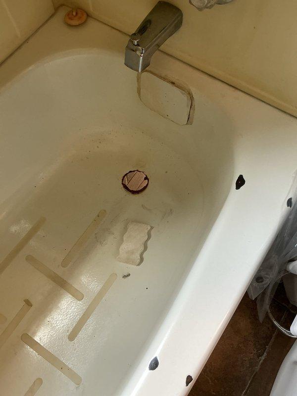 Responded to service call for bathtub drain replacement. Upon inspection, found existing drain assembly to be severely rusted and deteriorating, requiring complete removal and replacement. Removed old corroded drain fitting and installed new 4-inch flange assembly with matching drain cover in bronze finish. Ensured proper seal and tested for leaks to confirm watertight installation and proper drainage function.