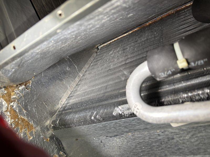 Responded to service call for 8-year-old air conditioning system experiencing reduced efficiency following recent duct cleaning. Upon inspection, found evaporator coil contaminated with fibers and debris that had been dislodged during the duct cleaning process and subsequently drawn into the coil assembly. Performed thorough evaporator coil cleaning to remove accumulated fibers, dust, and particulate matter from the aluminum fins and heat exchange surfaces. Documented pre-cleaning condition showing significant debris accumulation on coil fins. Restored proper airflow through the coil assembly and verified system operation. Discussed preventive maintenance program options with customer.