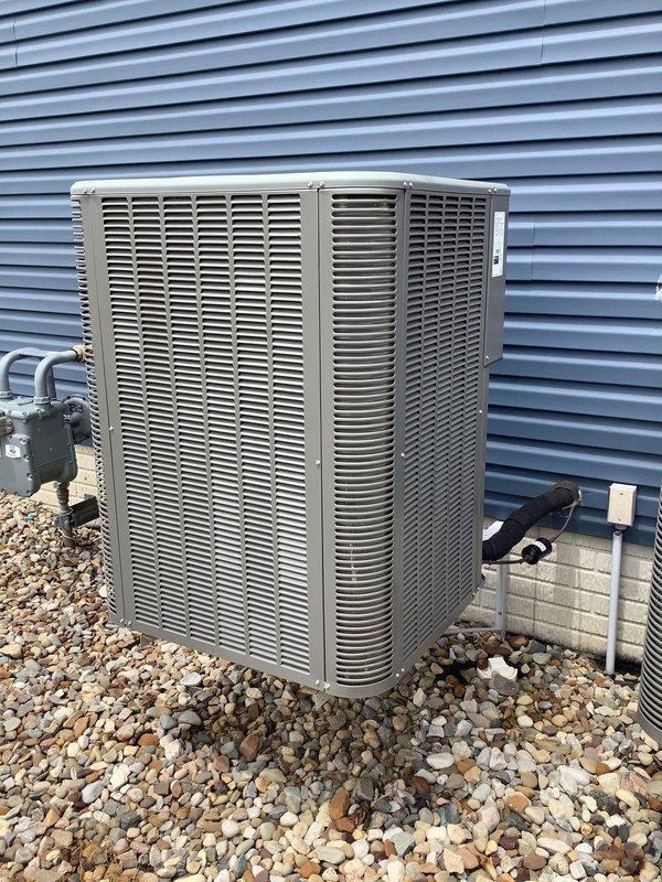 Responded to service call for two AC units, with one unit producing loud banging noise upon startup. Inspected outdoor condensing unit and internal electrical components. Examined capacitor assembly, wiring connections, and associated electrical terminals. Capacitor showed signs of weathering consistent with outdoor installation but appeared operational. Verified proper wire connections at capacitor terminals and wire nut junctions. Documented unit condition and component configuration with photographs for service records.