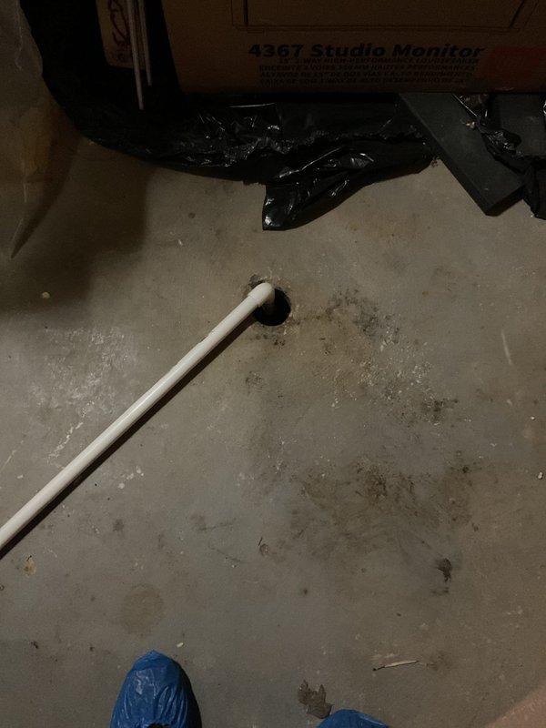 Responded to clogged drain issue near furnace in basement utility area. Upon arrival, found AC unit had been turned off to prevent continued water leakage from the blocked drain line. Assessed the drainage system and identified blockage in condensate drain line. Cleared obstruction from drain line to restore proper water flow and prevent future overflow. Verified drainage system was functioning correctly before restoring AC operation. Documented existing conditions of water heater, surrounding plumbing infrastructure, and work area with photos showing PVC drainage components and basement utility space layout.