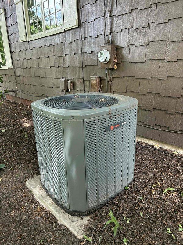 Completed routine cooling maintenance on a 14-year-old Trane air conditioning system as part of the MVP recurring service plan. Performed comprehensive inspection of outdoor condenser unit, verified proper operation of capacitor and electrical components, and documented system condition with interior and exterior photographs showing normal wear consistent with unit age.