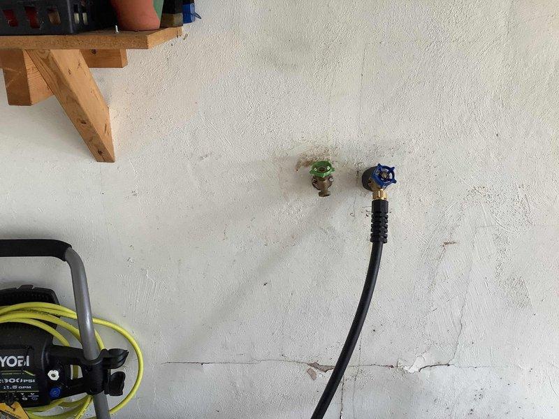 Responded to service call for leaking exterior hose bib that was recently installed. Upon inspection, identified leak at brass spigot connection point on exterior wall. Tightened compression fittings, verified proper sealing of threads, and tested water flow at both the brass hose bib with green handle and adjacent blue-handled valve to ensure no further leakage. System tested and confirmed operational with no active leaks detected.