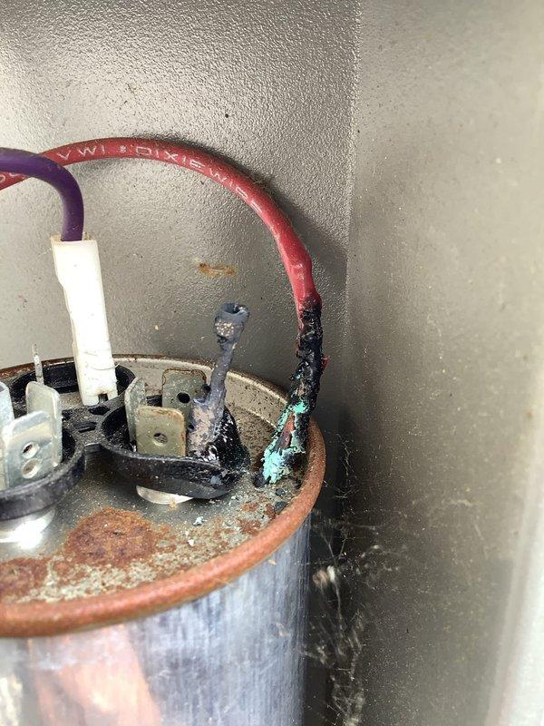 Responded to service call for 19-year-old Lennox air conditioning condenser unit producing excessive noise. Upon inspection, identified failed dual run capacitor exhibiting severe corrosion, rust deterioration on terminal connections, and turquoise-colored copper oxidation buildup around wire terminals. Replaced defective capacitor with new unit, verified proper electrical connections, and tested system operation. Unit now running quietly with normal operating parameters restored.