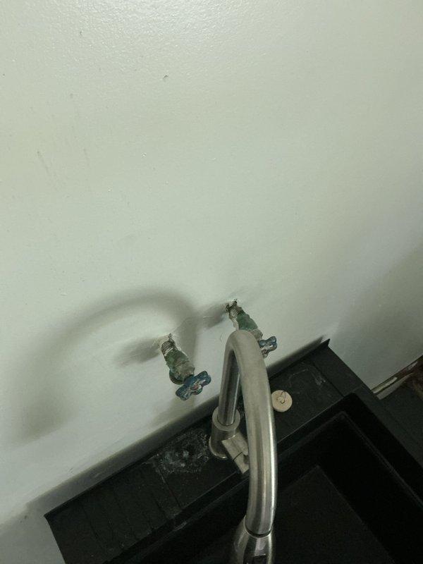 Replaced leaking washing machine supply valves in duplex utility rooms. Installed new quarter-turn shut-off valves for both hot and cold water lines on both sides of the property, as the original valves were leaking when activated. All new valves tested and verified operational with no leaks detected.