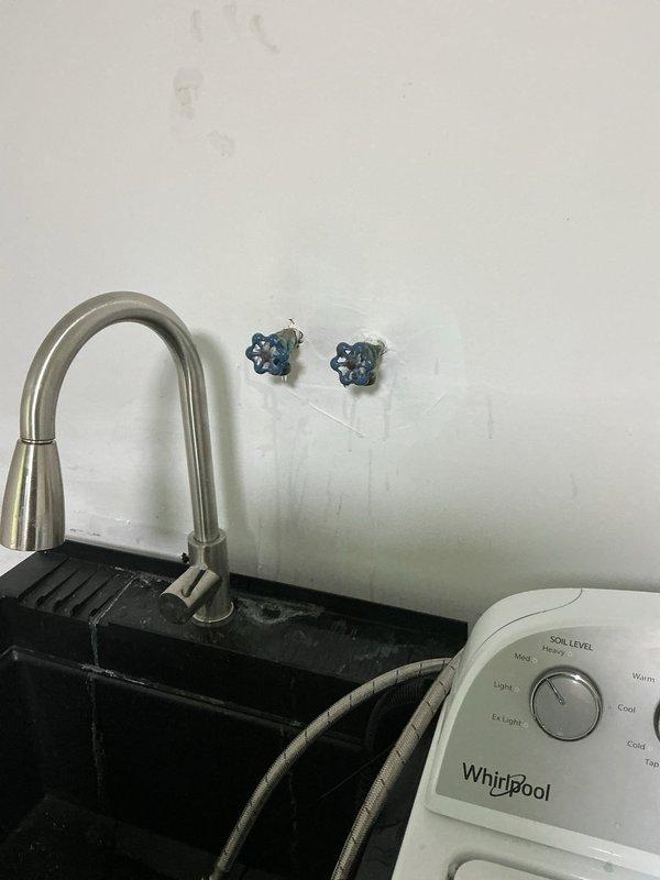Replaced leaking washing machine supply valves in duplex utility rooms. Installed new quarter-turn shut-off valves for both hot and cold water lines on both sides of the property, as the original valves were leaking when activated. All new valves tested and verified operational with no leaks detected.