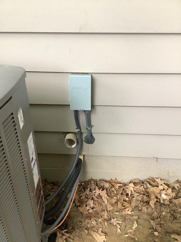 Relocated furnace circuit and installed new 40-amp dedicated circuit for outdoor air conditioning condenser unit. Ran electrical conduit from interior panel through basement joists to exterior disconnect box mounted on building siding, utilizing existing wire pathway where possible to minimize material usage. Installed weatherproof disconnect switch at exterior unit location and verified proper amperage rating for AC compressor load requirements. All wiring installed per NEC standards with appropriate gauge conductors for circuit protection and equipment specifications.