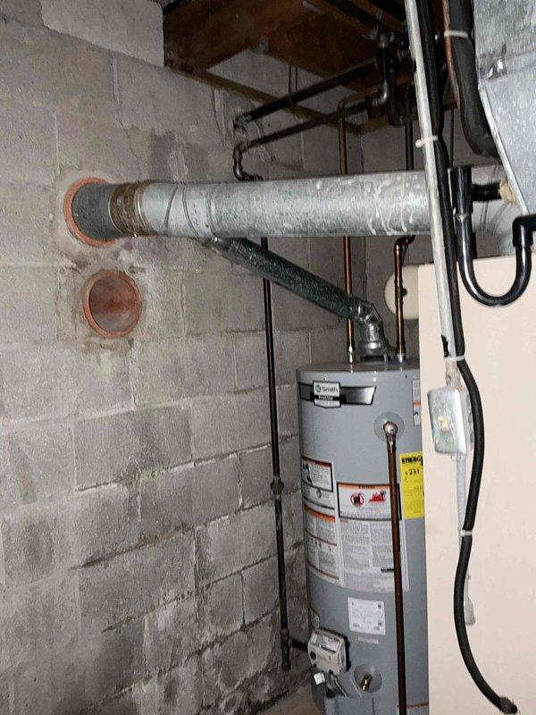 Conducted on-site assessment of existing HVAC system in basement mechanical room to provide replacement estimate for furnace and air conditioning equipment. Evaluated current air handler unit, ductwork configuration, and associated piping systems including copper refrigerant lines and PVC condensate drainage. Documented existing installation conditions, noting dust accumulation on flexible ductwork and aging infrastructure. Photographed equipment specifications, clearances, and utility connections to determine proper sizing and compatibility requirements for replacement system.