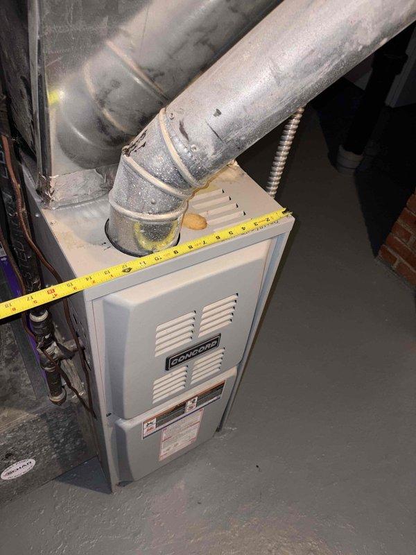 Conducted comprehensive HVAC system assessment for air conditioning replacement estimate. Evaluated existing OXBOX furnace installation in basement utility area, documenting current ductwork configuration and measuring equipment dimensions for compatibility planning. Inspected attic space to assess accessibility and structural considerations for potential air handler or evaporator coil placement, noting existing insulation conditions and available working area for new equipment installation.