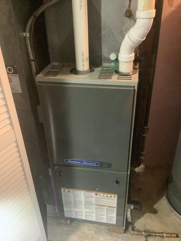 Provided comprehensive estimate for complete furnace and air conditioning system replacement at residential property. Evaluated existing American Standard furnace installation in basement utility area, assessed current PVC venting configuration, and documented existing equipment specifications to determine appropriate replacement options for both heating and cooling systems.