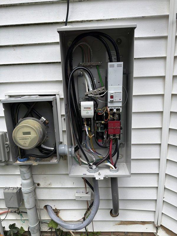 Completed installation of 24kW standby generator system with 200-amp automatic transfer switch on residential property. Ran 50 feet of electrical conduit from main service panel to generator location, installed new exterior-mounted transfer switch panel with appropriate circuit breakers and surge protection, and connected 15 feet of gas line to fuel supply. Generator unit mounted on concrete pad with proper clearances, all conduit secured to building exterior, and system tested for proper automatic transfer operation during simulated power outage.