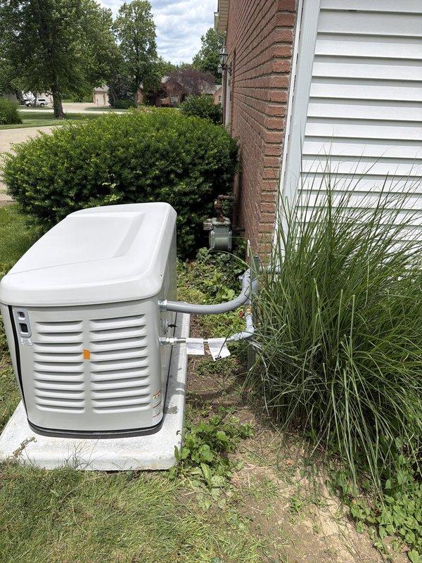 Completed installation of 24kW standby generator system with 200-amp automatic transfer switch on residential property. Ran 50 feet of electrical conduit from main service panel to generator location, installed new exterior-mounted transfer switch panel with appropriate circuit breakers and surge protection, and connected 15 feet of gas line to fuel supply. Generator unit mounted on concrete pad with proper clearances, all conduit secured to building exterior, and system tested for proper automatic transfer operation during simulated power outage.