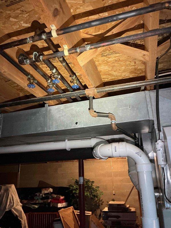 Conducted comprehensive electrical estimate for backup generator installation at residential property. Assessed existing electrical infrastructure including main service panel, circuit breaker configuration, and utility space layout to determine optimal integration point for generator transfer switch. Documented current electrical distribution system featuring dual-column breaker arrangement in main panel, existing gas piping with shutoff valves in basement ceiling area, and available mounting locations for required equipment. Evaluated structural considerations including OSB ceiling construction, existing HVAC ductwork placement, and PVC drainage routing to identify clear pathways for generator feeder cables and outdoor equipment placement. Photographed electrical panel specifications and basement utility infrastructure to support equipment sizing recommendations and installation planning.