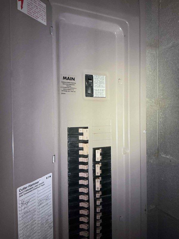 Conducted comprehensive electrical estimate for backup generator installation at residential property. Assessed existing electrical infrastructure including main service panel, circuit breaker configuration, and utility space layout to determine optimal integration point for generator transfer switch. Documented current electrical distribution system featuring dual-column breaker arrangement in main panel, existing gas piping with shutoff valves in basement ceiling area, and available mounting locations for required equipment. Evaluated structural considerations including OSB ceiling construction, existing HVAC ductwork placement, and PVC drainage routing to identify clear pathways for generator feeder cables and outdoor equipment placement. Photographed electrical panel specifications and basement utility infrastructure to support equipment sizing recommendations and installation planning.